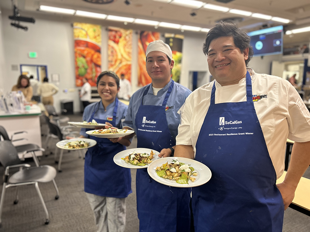 Culinary Arts Students hold plates in a competition